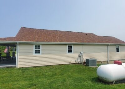 house with light siding and red roof